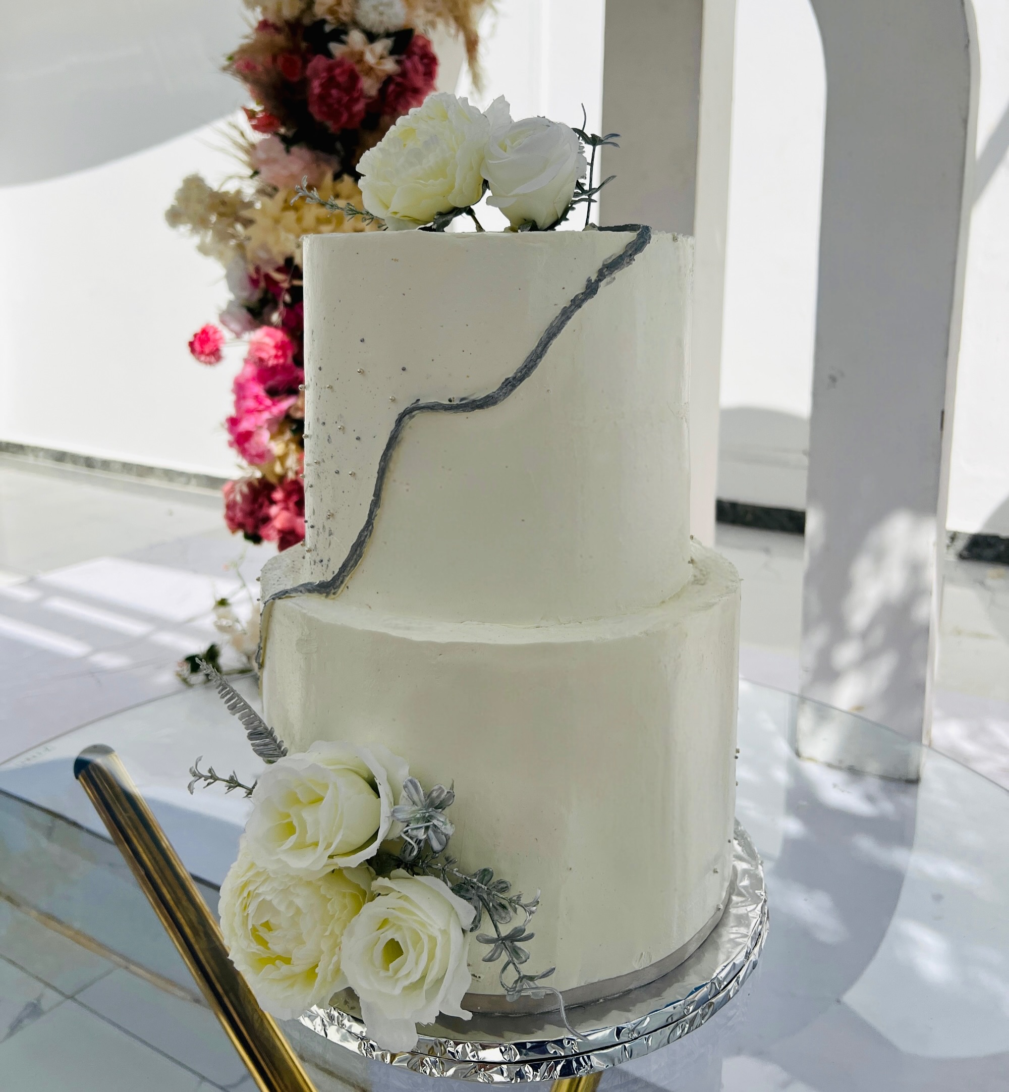 White two-tier wedding cake with flowers